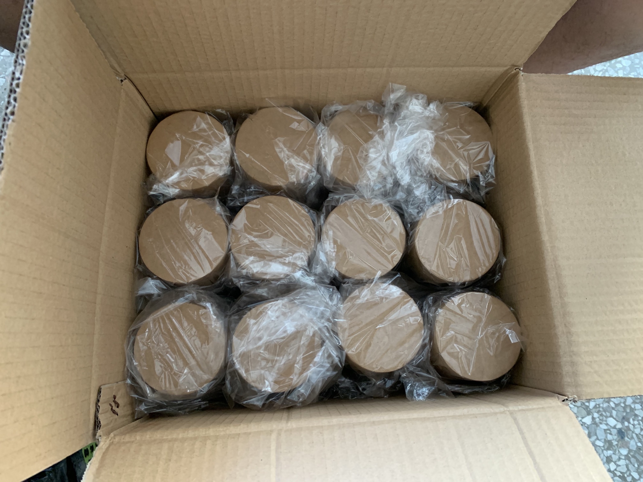 Original top-down photograph of individually bagged kraft tubes packed in a carton