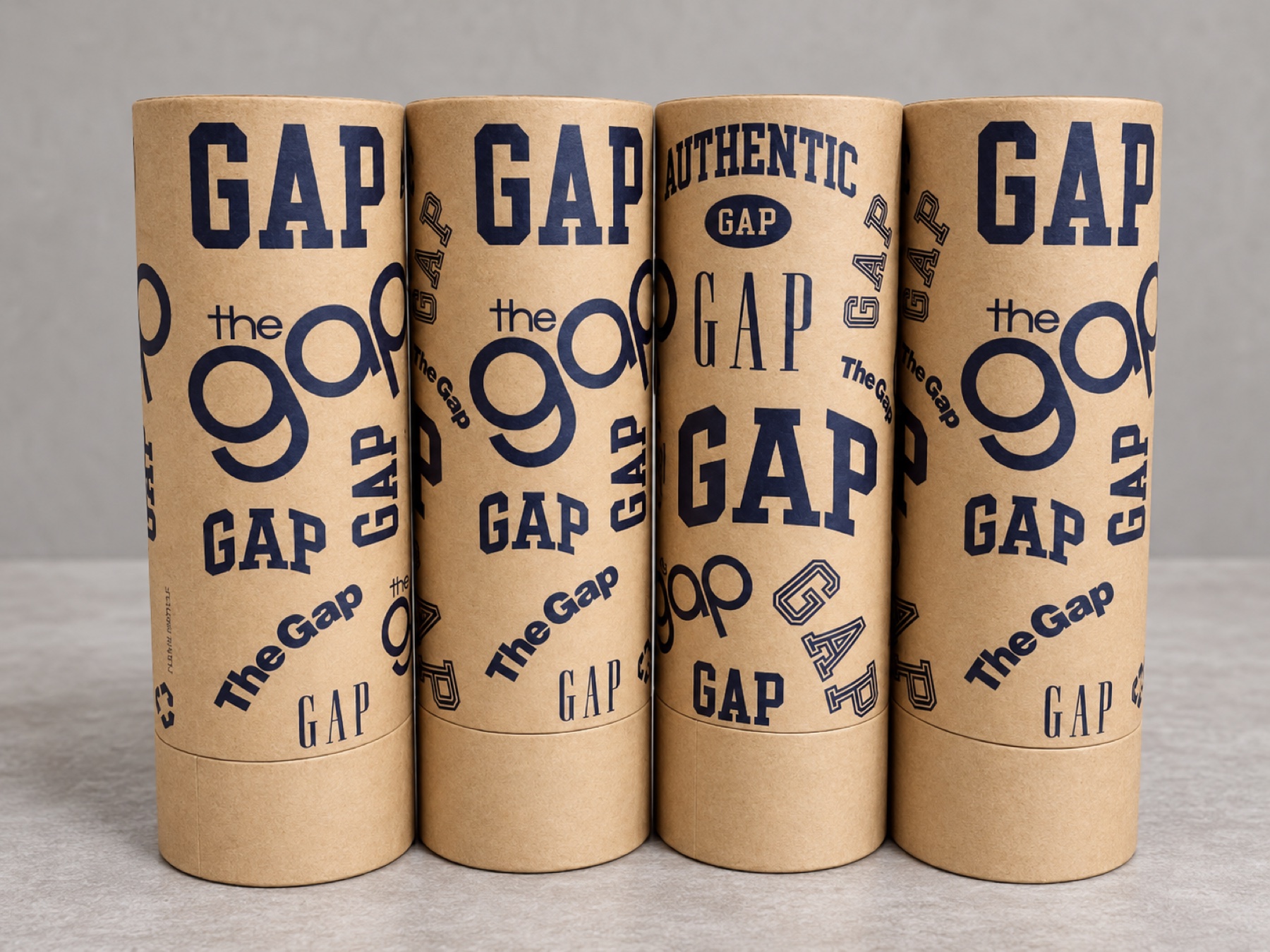 Four completed dark-blue printed cylindrical kraft tubes