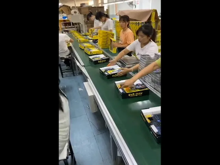 Workers assembling and checking custom gift boxes on the production line